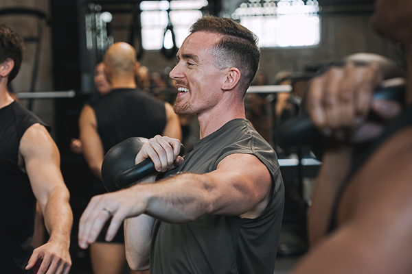 Dale holding a kettlebell in the rack position. 