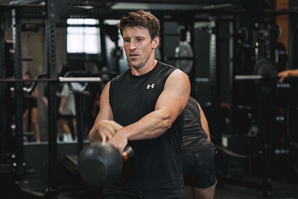 Garen performing a kettlebell swing.